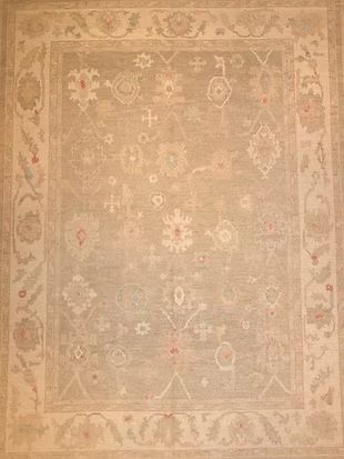 A rug with a floral pattern on it is sitting on a table.