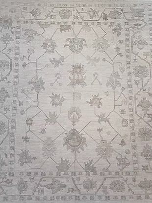 A close up of a rug with a floral pattern on it.