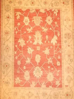 A red and white rug with a floral pattern on it