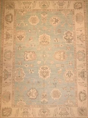 A blue and white rug with a floral pattern on it.