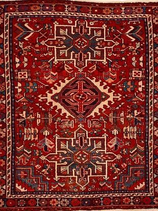 A red rug with a geometric pattern on it