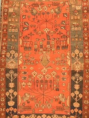 A close up of a rug with a floral pattern on it.