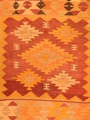 A close up of a rug with a geometric pattern on it