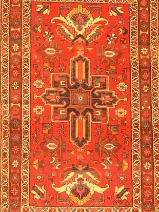 A red rug with a floral pattern on it
