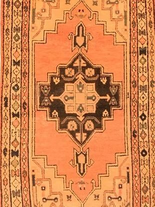 A close up of a rug with a geometric pattern