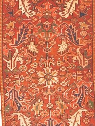 A red rug with a floral pattern on it