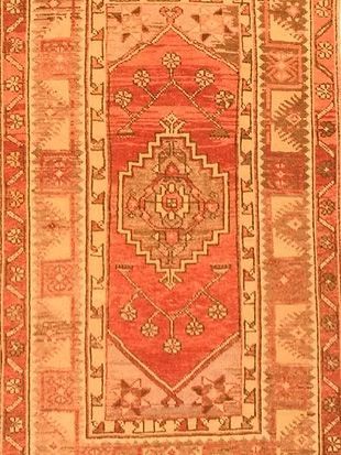 A close up of a rug with a geometric pattern on it