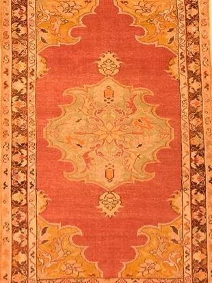 A red and yellow rug with a floral pattern on it
