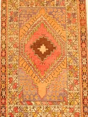 A rug with a geometric pattern and a cross on it