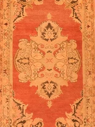 A red rug with a floral pattern on it