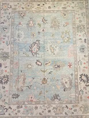 A rug with a floral pattern on it is sitting on a table.