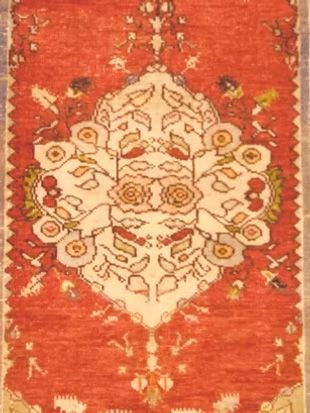 A red and white rug with a floral pattern on it
