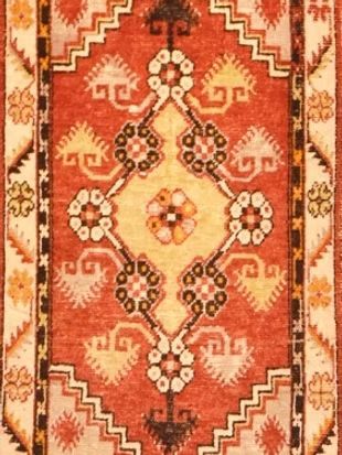 A close up of a rug with a geometric pattern