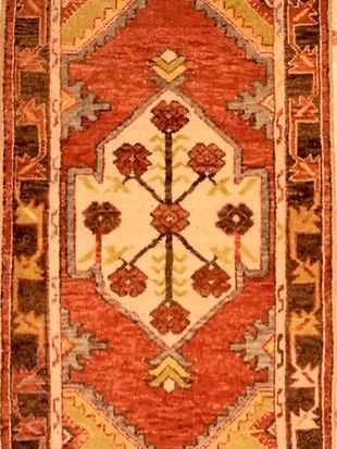 A rug with a geometric pattern and flowers on it