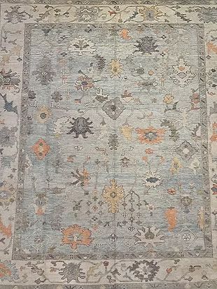 A close up of a rug with a floral pattern on it.