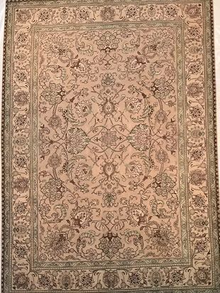 A rug with a floral pattern on it is sitting on a table.