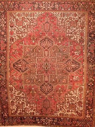 A close up of a red rug with a pattern on it.