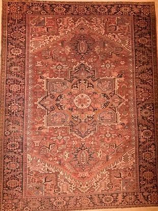 A rug with a floral pattern is sitting on a table.