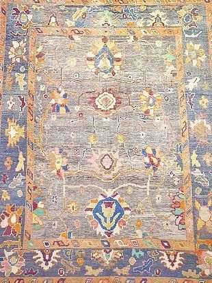 A close up of a rug with a floral pattern on it.