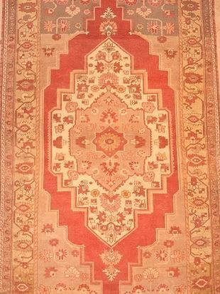 A red and white rug with a floral pattern on it