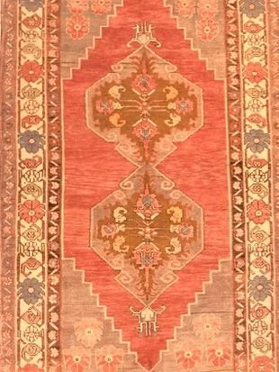 A red rug with a geometric pattern on it