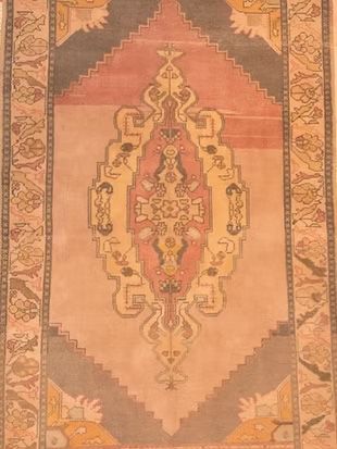 A rug with a floral pattern on it is sitting on a table.