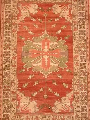 A red rug with a pattern on it is sitting on a table.