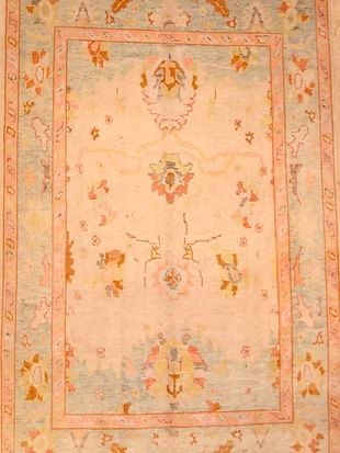 A close up of a rug with a floral pattern on it.