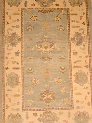 A rug with a floral pattern on it is sitting on a table.