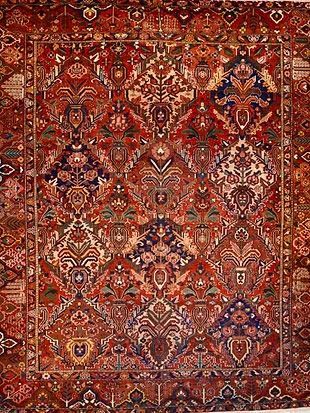 A close up of a rug with a floral pattern on it.