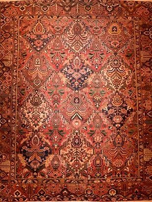 A close up of a rug with a floral pattern on it.