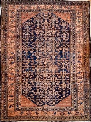 A rug with a pattern on it is hanging on a wall.