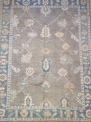 A rug with a floral pattern on it is sitting on a wooden table.