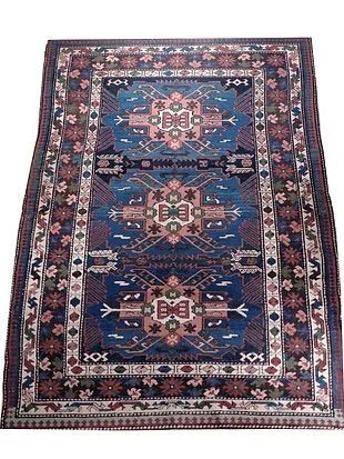 A rug with a floral pattern on it is on a white background.