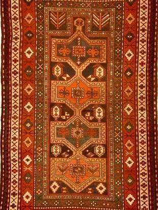 A red rug with a geometric pattern on it