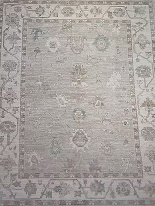 A close up of a rug with a floral pattern on it.