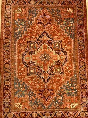 A close up of a rug with a floral pattern on it.