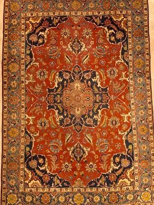 A rug with a floral pattern on it is sitting on a table.