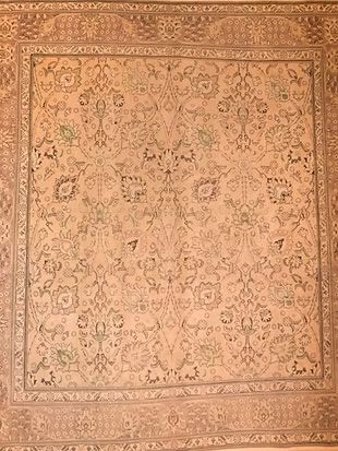 A rug with a floral pattern on it is sitting on a table.