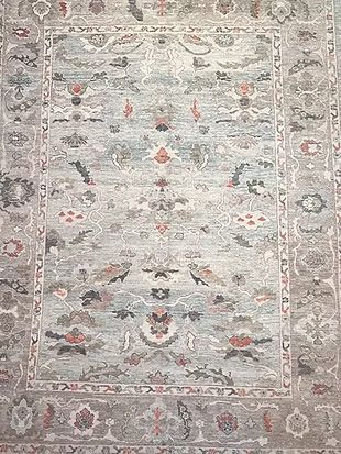 A close up of a rug with a floral pattern on it.