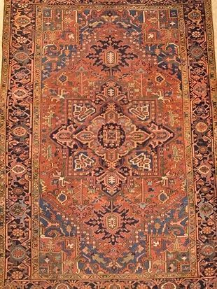 A close up of a rug with a floral pattern on it.