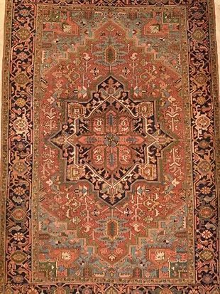 A close up of a rug with a floral pattern on it.