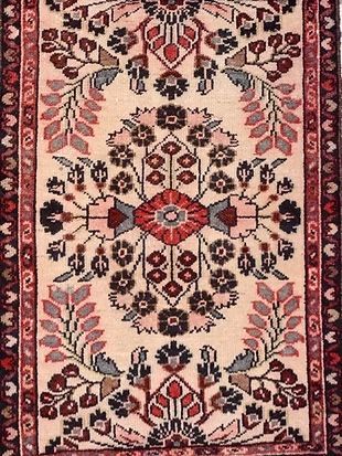 A close up of a rug with a floral pattern on it.