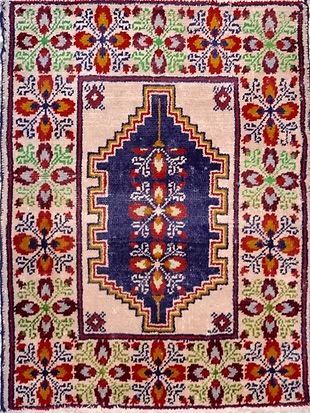 A rug with a floral pattern on it is sitting on a table.