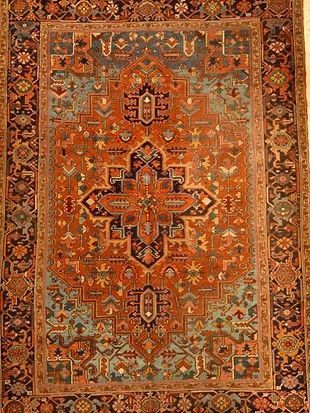A close up of a rug with a floral pattern on it.