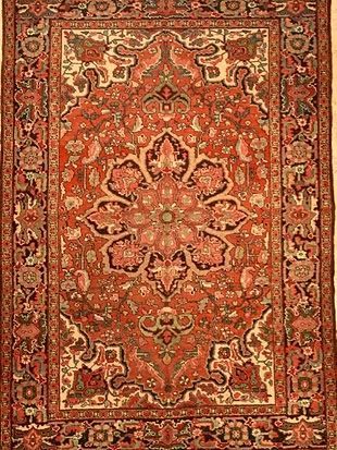 A rug with a floral pattern on it is sitting on a table.