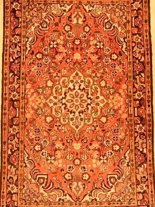 A close up of a rug with a floral pattern on it.