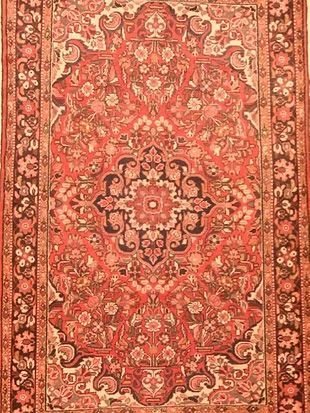 A close up of a rug with a floral pattern on it.