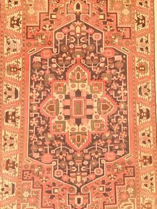 A close up of a rug with a geometric pattern on it.