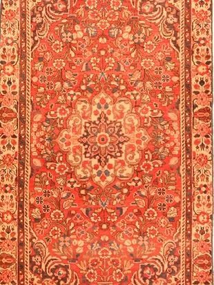 A close up of a rug with a floral pattern on it.